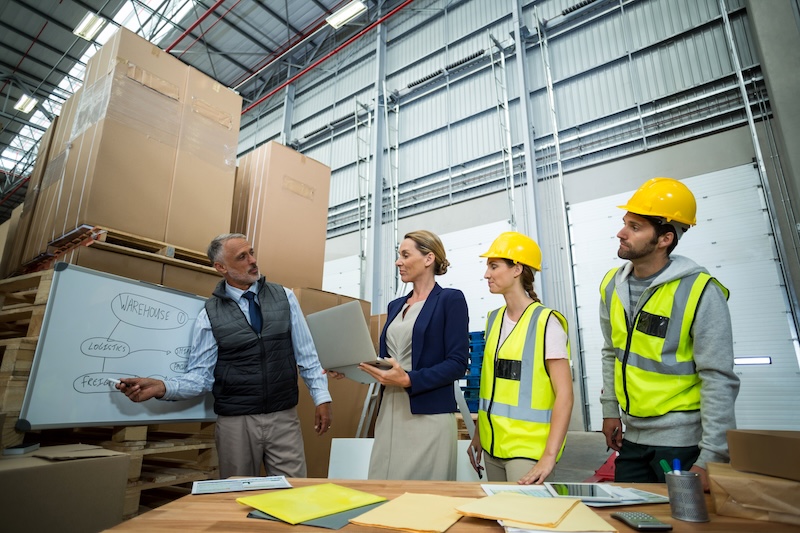 warehouse-workers-and-managers-discussing-plan-on
