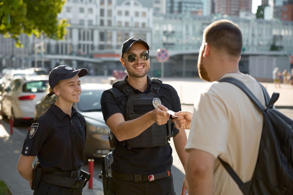 friendly-smiling-patrol-policeman-giving-back-pass